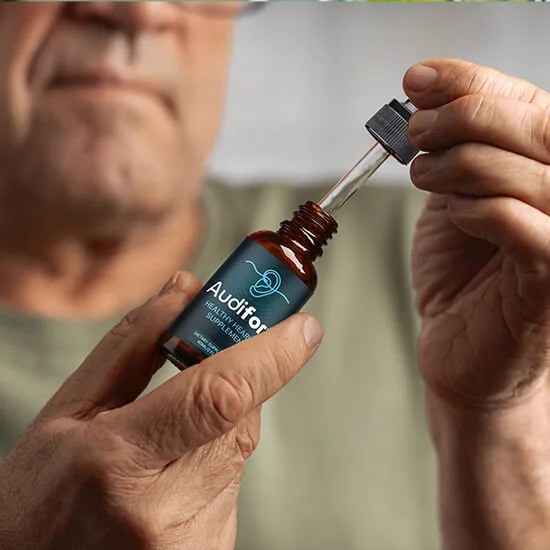 Man holding Audifort bottle with dropper 